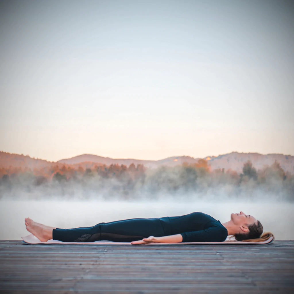 woman in Savasana stance, focusing on body awareness